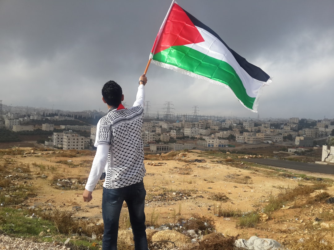 Palestinian man waiving a Palestinian flag
