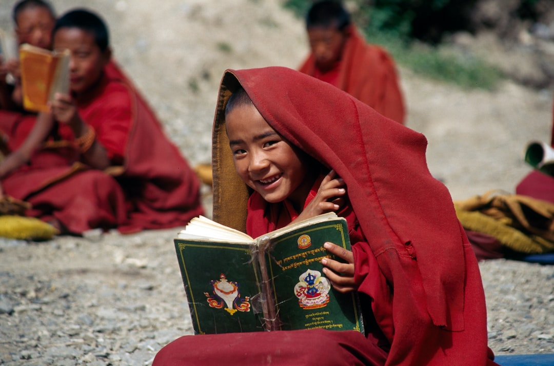 Buddhist children reading books outside